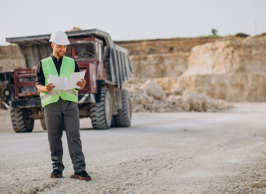 Male worker with bulldozer in sand quarry