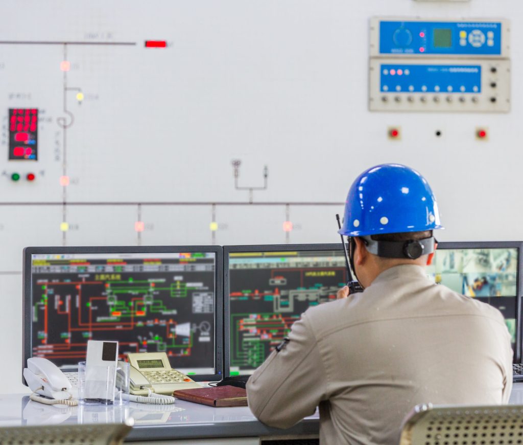 workers in control room of a factory.